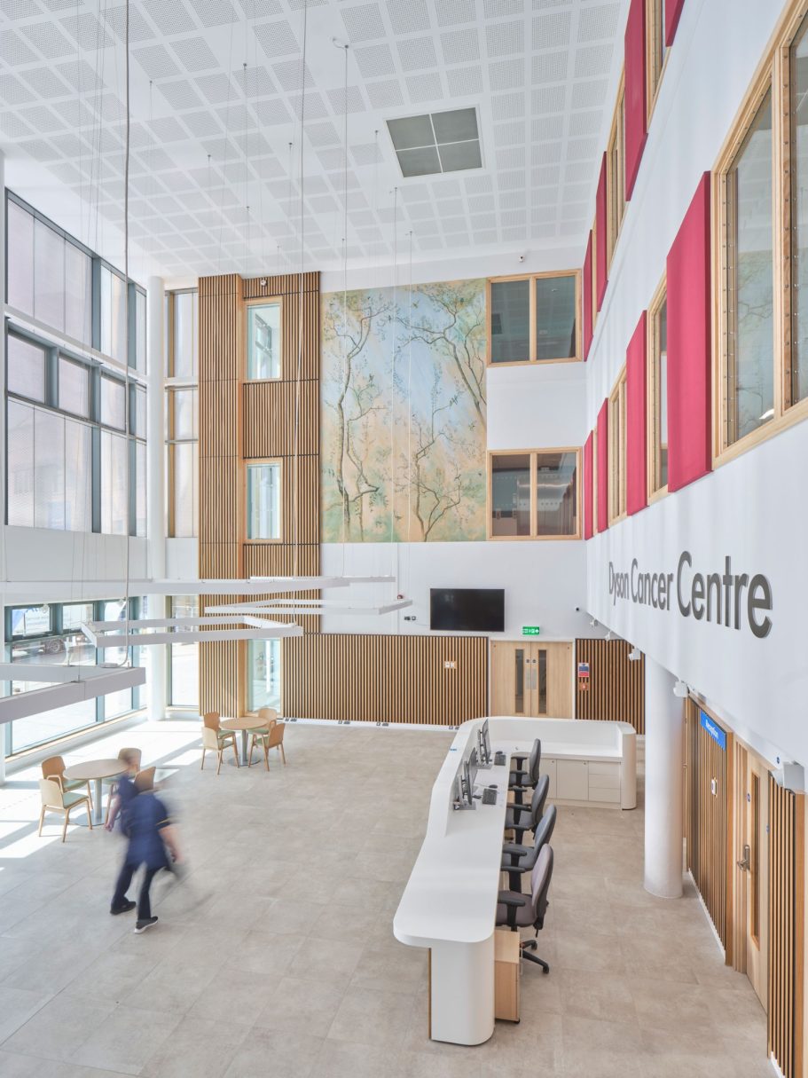Dyson Cancer Centre, Bath, UK Modern interior of a welcoming reception area with wooden accents and large windows.