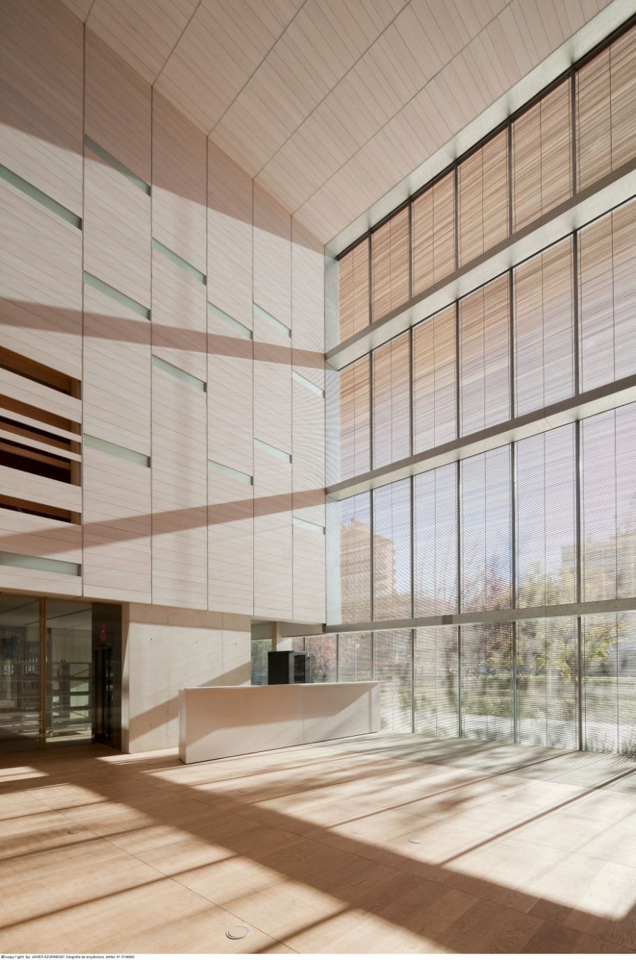 Archivo Histórico Provincial de Guadalajara, Spain Modern interior with large windows, wooden flooring, and sleek architectural lines.