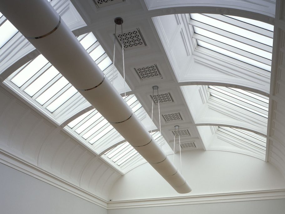 Tate Britain, UK Bright, airy ceiling with skylights and a long horizontal beam.