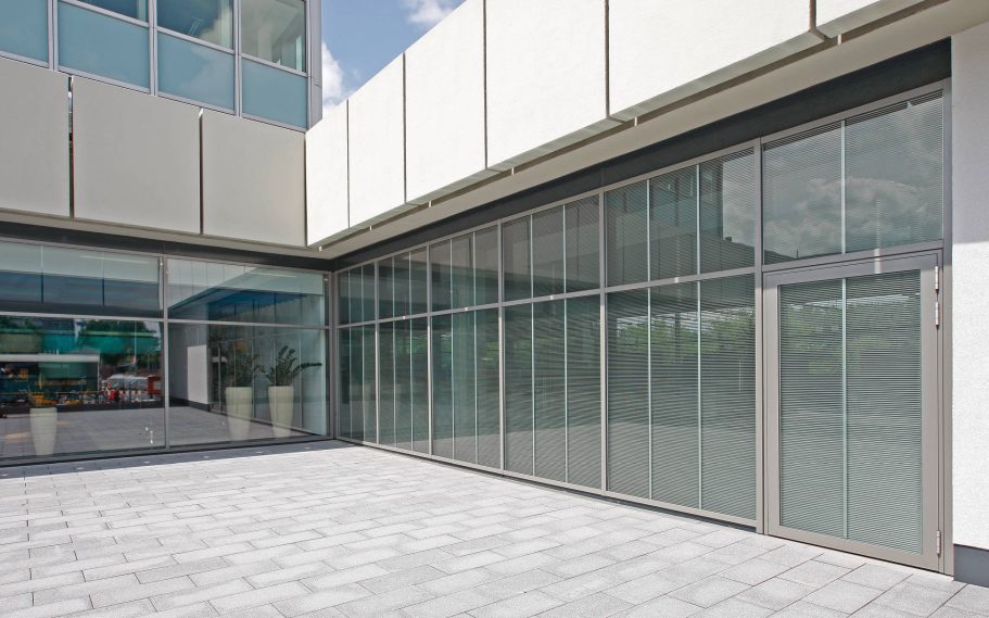 MVV Energie AG, Mannheim, Germany Modern building facade with large glass panels and a tiled entrance area.
