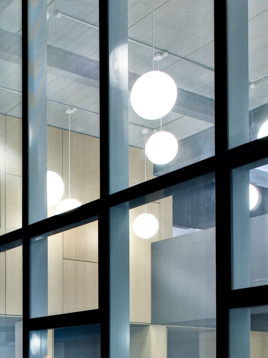 University of Kent, Jarman Building Interior view of a modern building with large windows and circular light fixtures.
