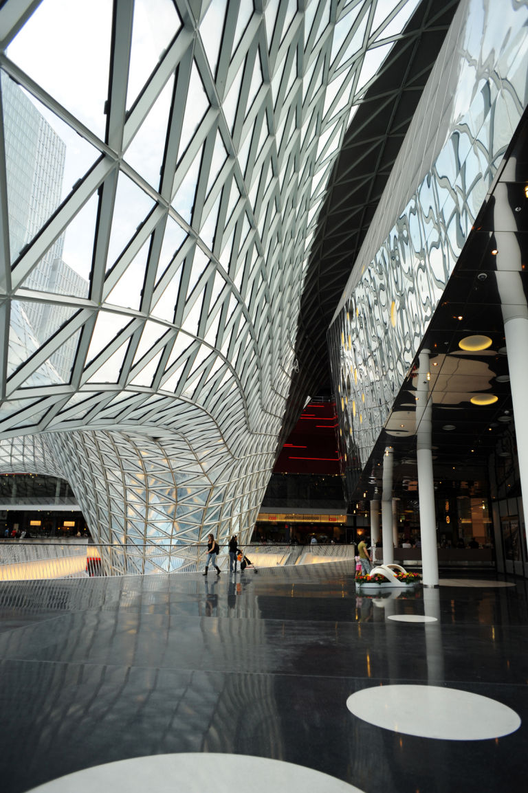 MyZeil Shopping Centre, Frankfurt, Germany Modern interior featuring curved glass walls and a sleek, spacious design.