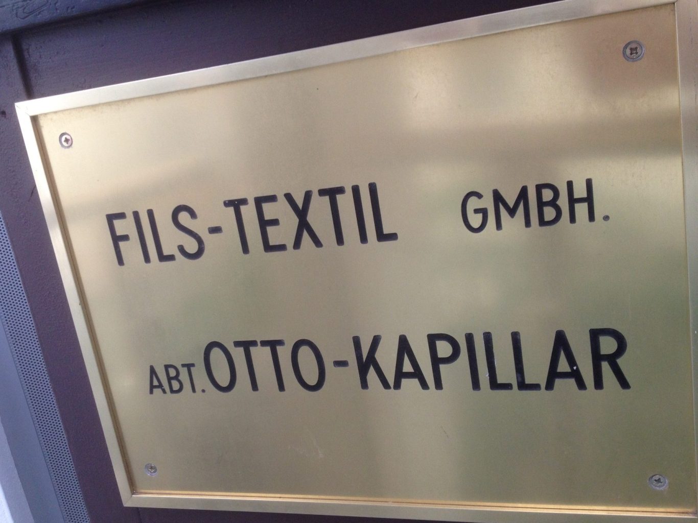 Metal sign displaying "FILS-TEXTIL GMBH. ABT OTTO-KAPILLAR."